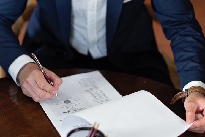 arizona-llc-vs-corporation-business-structure Business professional reviewing LLC and corporation formation documents in Arizona
