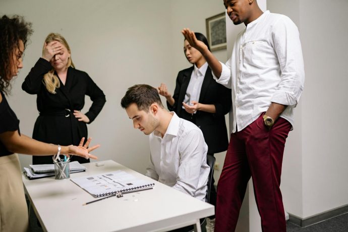 Business dispute meeting Business colleagues in a tense discussion over documents at a conference table