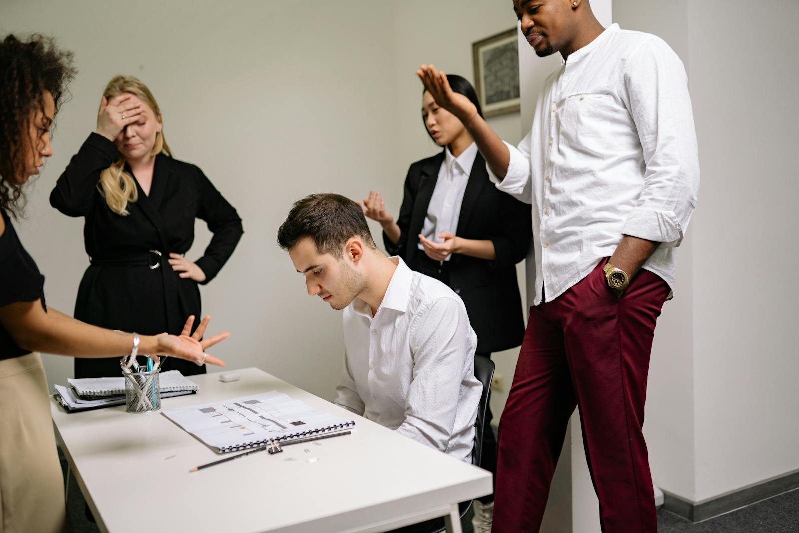 Business colleagues in a tense discussion over documents at a conference table